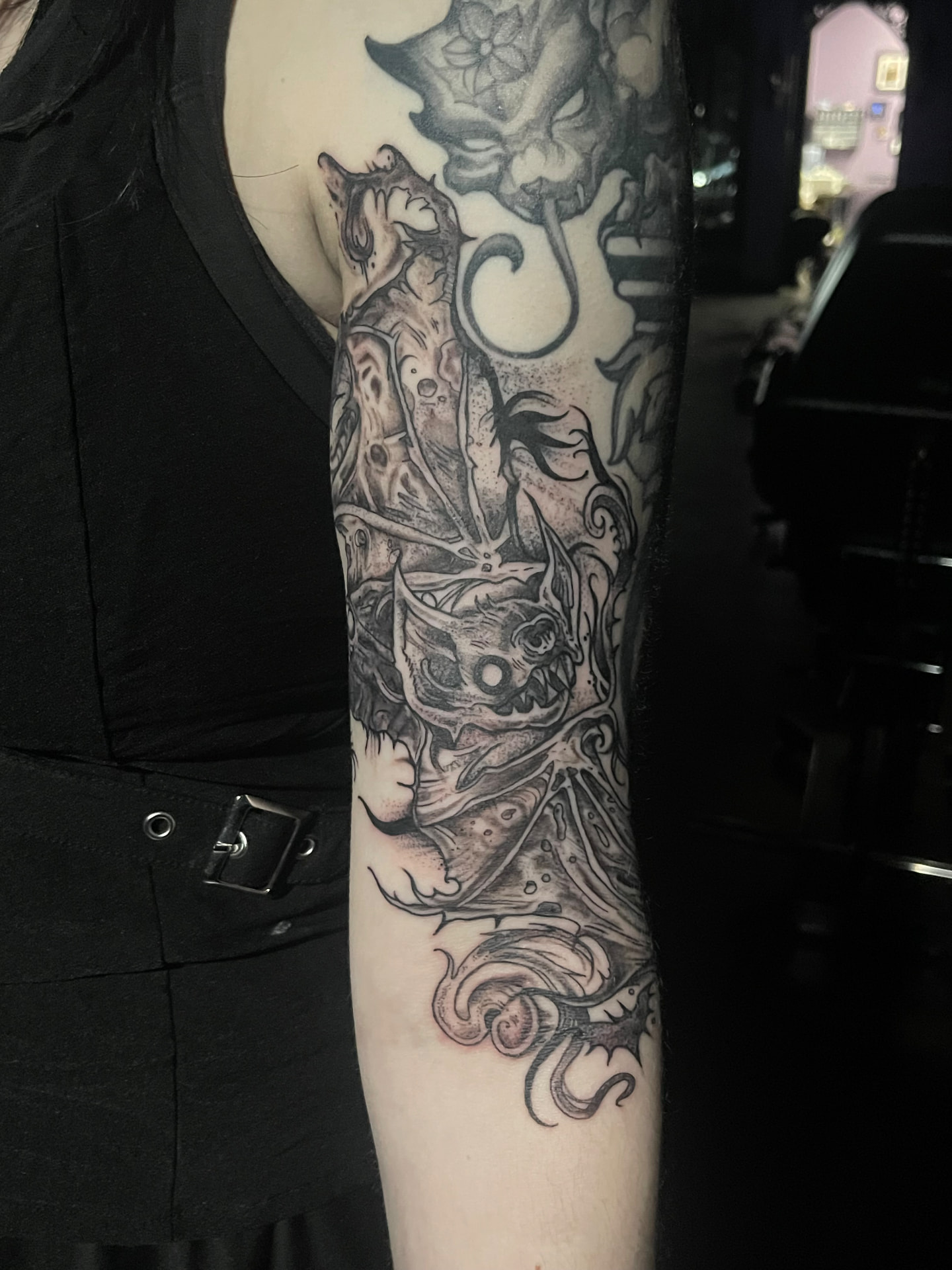 Dark illustrative gremlin and gargoyle sleeve with flowing ornament