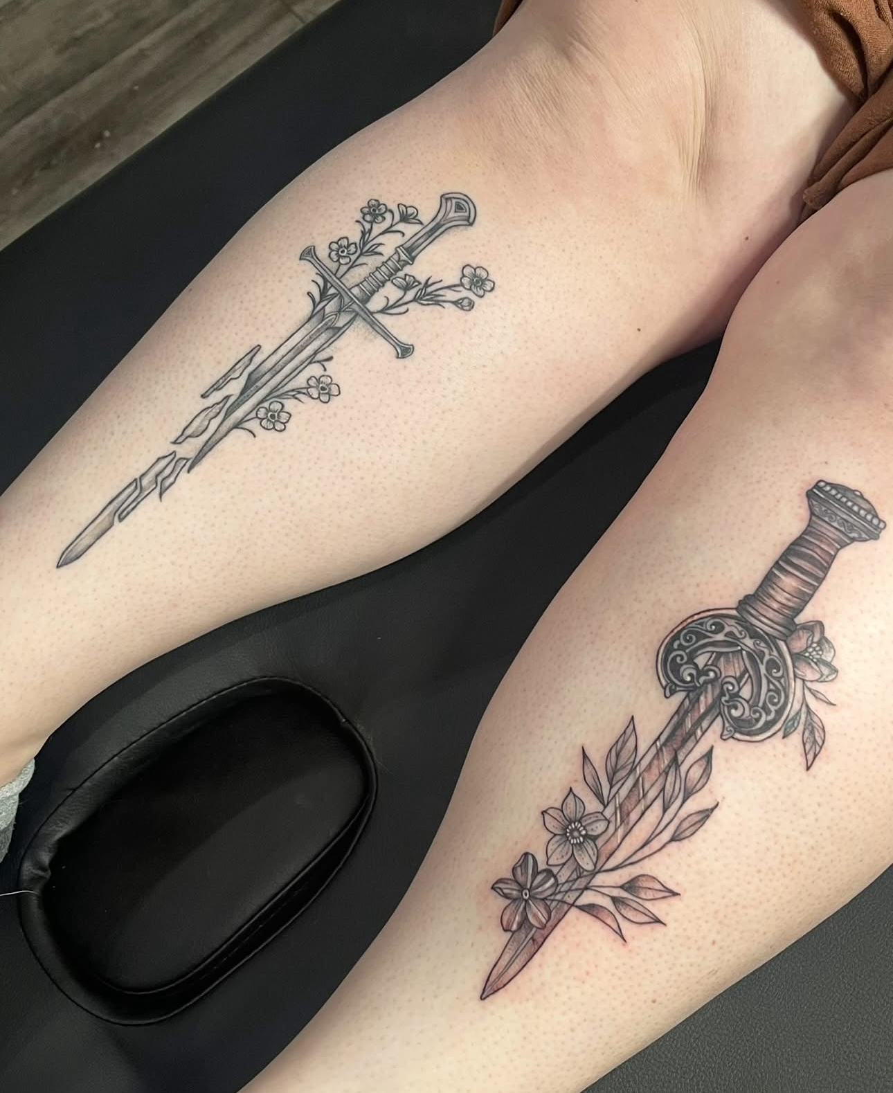 Fine line shattered sword with wildflowers and a wreathed dagger with botanical leaves