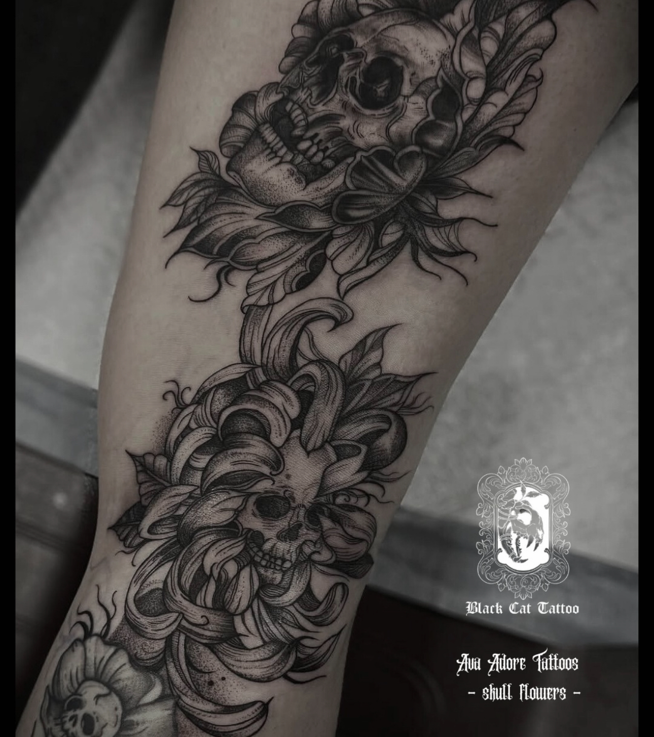 Skull flowers leg piece in black and grey with dotwork shading