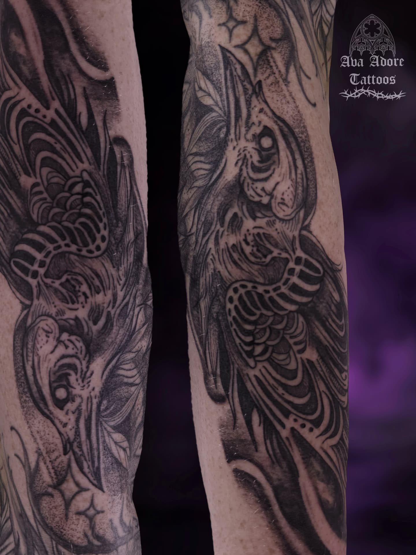 Blackwork raven sleeve wrapping both forearms with feathered linework and dotwork shading